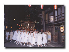 A portable shrine is paraded through the streets of Terashita.